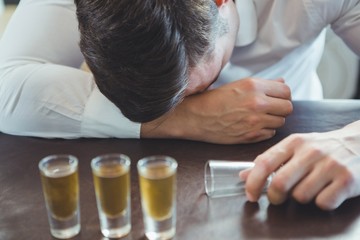 Wall Mural - Drunken man sleeping on a bar counter