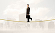 © ra2 studio - Business person balancing on golden rope