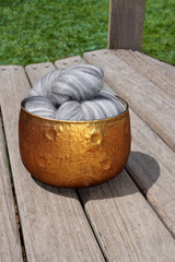 Wall Mural - Gray variegated Merino sheep wool fiber in a copper glass bowl