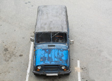 Old Russian Car  With Shabby Blue Paint Stay On Parking. A Canvas Top..