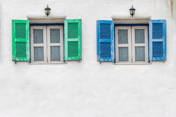 Old blue window and Old green window with white wall