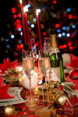 Wall Mural - christmas eve party table with champagne flute with red and golden glitter