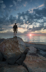 Winner silhouette on the rocks. Sport and active life concept..