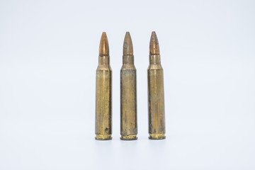 Wall Mural - old rifle cartridges 5.56 mm on a white background