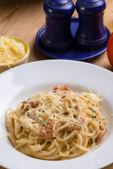 spaghetti carbonara on wooden table