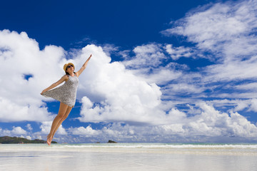 Poster - Beautiful woman jumping at the beach