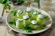Cucumber rolls stuffed with feta cheese, dill and olives on a ta