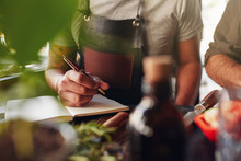 Man Creating New Cocktail Recipe And Taking Notes