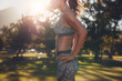 © Jacob Lund - Fit woman athlete in sportswear standing at a park