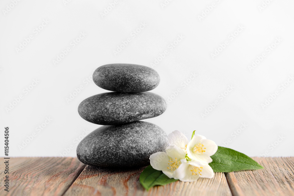 Gray spa stones on light background