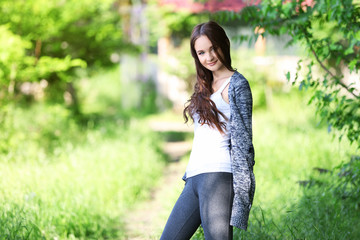 Wall Mural - Young beautiful girl walking in park