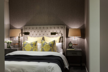 Luxury bedroom illuminated at night with table lamps  closeup