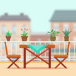 © elvetica - Table and chairs on the balcony.