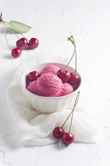 Wall Mural - Cherry ice cream and cherries on white surface.