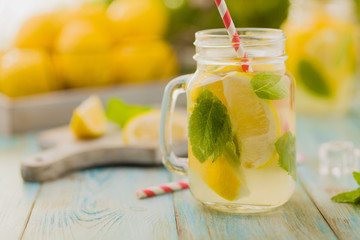 Wall Mural - lemonade with mint on rocks served in jar with a straw