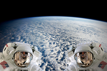 high resolution planet earth two astronauts spaceman helmet suit floating people outer space walk. e