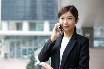 Wall Mural - Asian business woman talk to mobile phone