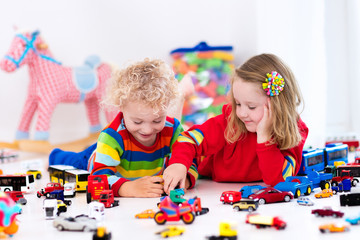 Wall Mural - Little kids playing with toy cars