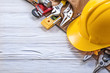 Construction belt hard hat on wooden board maintenance concept