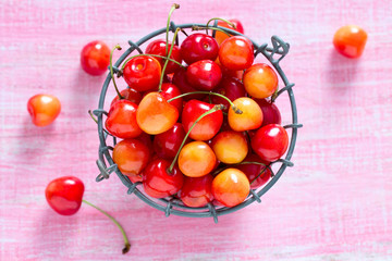 yellow and pink cherries on wooden surface