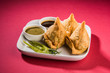 samosas or samosa - Indian deep fried snack, served with chutney and fried green chilly