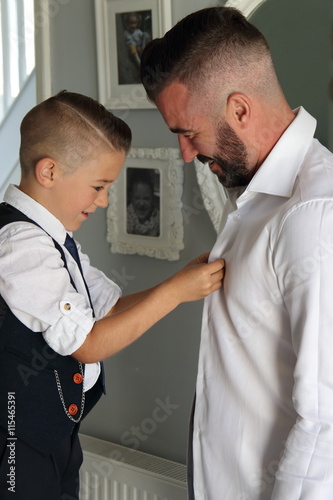 A Young Boy Dressing His Father On Wedding Day As Part Of A Young Boy Dressing His Father On Wedding Day As Part Of Best Man