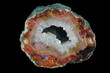A cross section of the agate stone with geode on  the black background. Origin: Asni, Morocco.