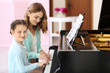 © Africa Studio - Small girl learning play piano with teacher