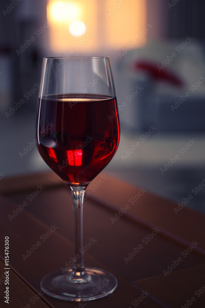 Glass of red wine on blurred background