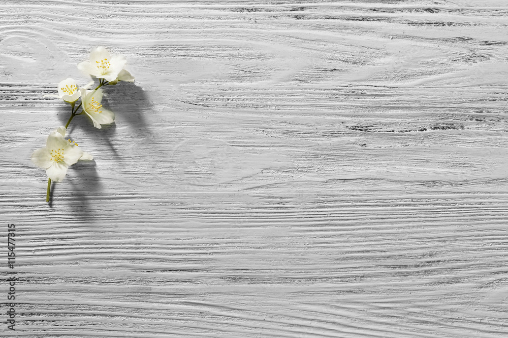 Fresh jasmine flowers on wooden background