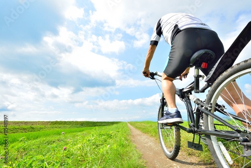 Cuadros en Lienzo Corro bicicletas de montaña en el paisaje del cielo y el campo