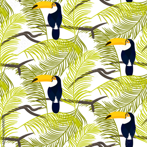 Foto Green palm leaves and toucan bird sitting on branch seamless vector pattern on white background