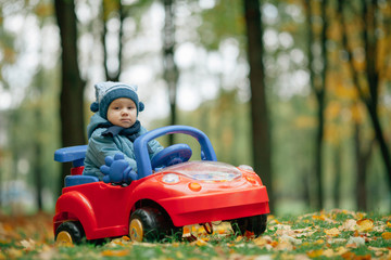 Wall Mural - little funny boy driving toy car