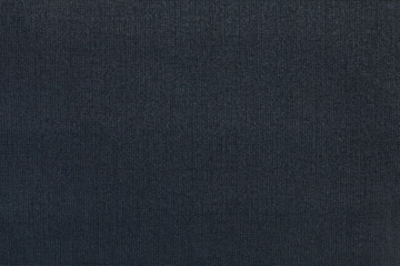 Dark blue background from a textile material. Fabric with natural texture. Backdrop.