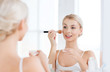 © Syda Productions - woman with makeup brush and powder at bathroom