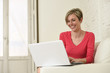 © Wordley Calvo Stock - young beautiful woman smiling happy working at home with laptop computer on sofa couch