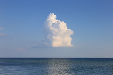 Alone Clouds Over Seascape. Billowing Cumulus Cloud Summer Day.