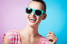 Colorful Portrait Of Happy Female Model Smiling And Wearing Sunglasses. 