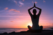 © kieferpix - Young healthy woman practicing yoga on the beach at sunset