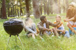 © Yakobchuk Olena - Cheerful men and woman making picnic