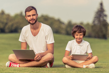 Wall Mural - Dad and son with gadget