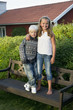 © FOLIO - Sweden, Stockholm, Girl (10-11) and boy (8-9) standing on bench