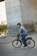 © FOLIO - Portrait of smiling man riding bicycle outdoors