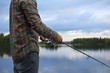 © FOLIO - Finland, Pirkanmaa, Lehtissaari, Man fishing in lake