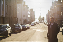 Finland, Helsinki, Businessman In Sunlit Street