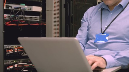 Poster - Technician using laptop to analyse server