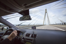 Sweden, Bohuslan, Uddevalla, Man Crossing Suspension Bridge In Car