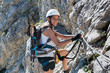 © XtravaganT - Woman in mountaineering gear doing a via ferrata