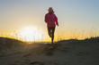 © FOLIO - Finland, Pohjanmaa, Pietarsaari, Faboda, Young woman jogging on beach at sunset