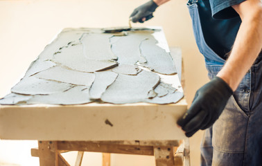 Wall Mural - man working with trowel and foam plastic at home renovation